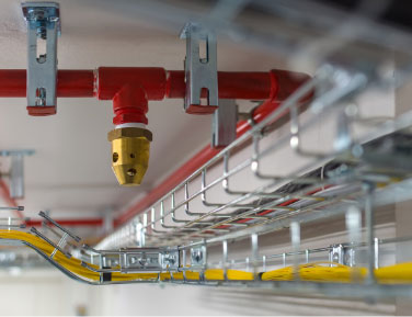 A close-up view of a metallic pipe alongside a bright yellow hose, showcasing their textures and colors.