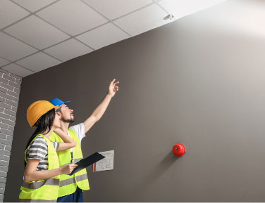 Two professionals conducting a Passive Fire Inspection in a commercial building.